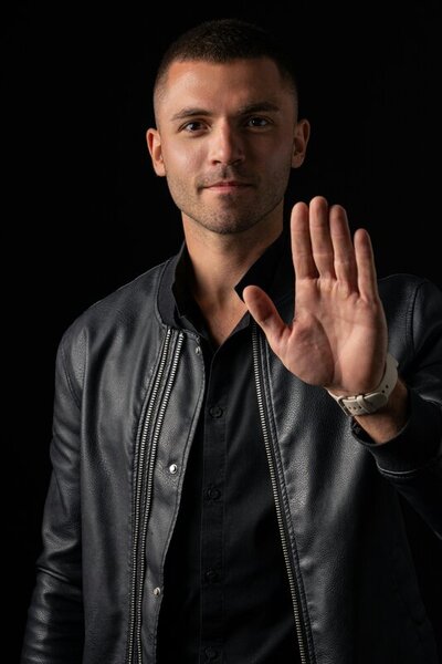 Photo by John Tekeridis: https://www.pexels.com/photo/man-in-black-leather-jacket-showing-palm-14037564/