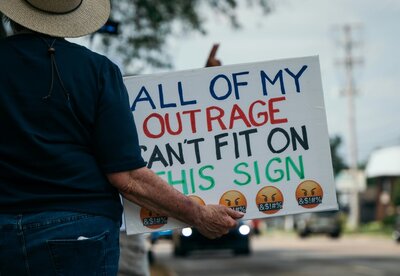 Photo by Chris F: https://www.pexels.com/photo/protester-holding-outrage-sign-at-a-rally-33509504/
